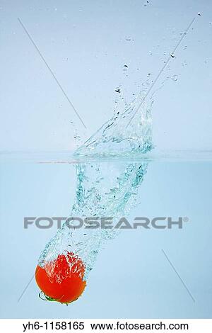 Stock Photography - Splash of water by tomato, Japan, Fukushima. Fotosearch