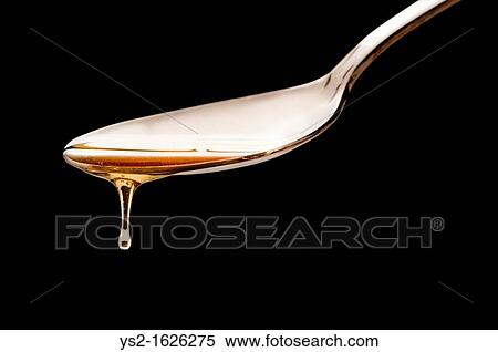 Stock Photography - Spoon with dripping honey. Fotosearch