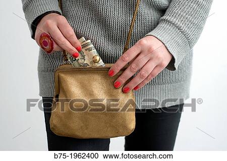 spotlight of hands taking dollars from a handbag View Large Photo Image Stock Image - spotlight of hands taking dollars from a handbag. Fotosearch