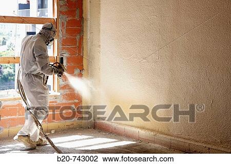 Stock Image - Spraying polyurethane foam, thermal and acoustic insulation, housing under construction. Donostia, Gipuzkoa, Basque Country, Spain. Fotosearch