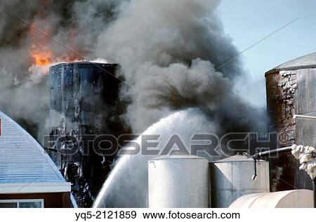 spraying water on fire at asphalt manufacturing plant, Canada, Ontario, Toronto. View Large Photo Image Stock Photo - spraying water on fire at asphalt manufacturing plant, Canada, Ontario, Toronto.. Fotosearch
