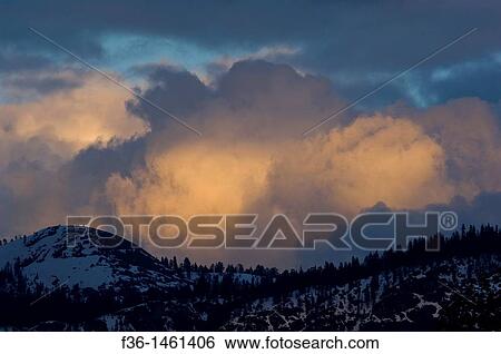Spring snow storm clouds at sunset over mountains, Yosemite National Park, California View Large Photo Image Stock Photograph - Spring snow storm clouds at sunset over mountains, Yosemite National Park, California. Fotosearch