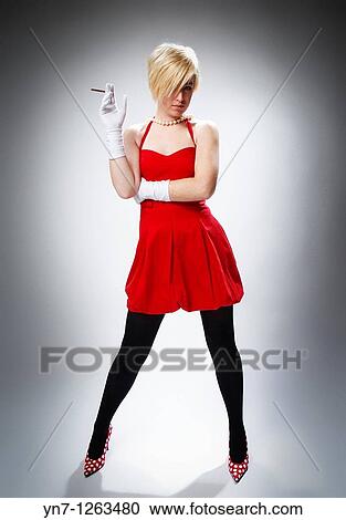 Stock Image - Spunky lady with cigar. Fotosearch