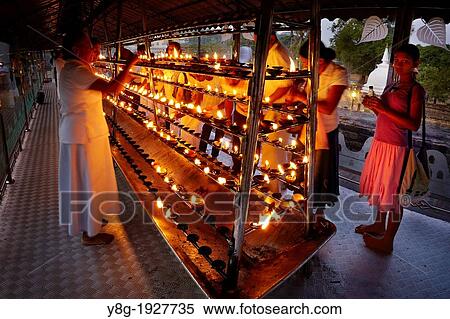 Stock Photography - Sri Lanka - Pilgrims light up candles in the Temple of the Tooth, UNESCO World Heritage Site, Buddhist shrine, Kandy, Sri Dalada Maligawa, central region of Sri Lanka. Fotosearch
