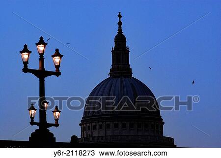 Stock Image - St. Paul's Cathedral in London, England, seen late in the evening, with Southwark Bridge in the foreground.. Fotosearch