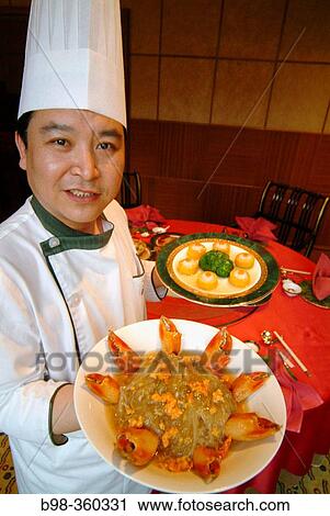 Stock Image - St. Regis Hotel's Chinese restaurant: chef with lobster claws. Beijing. China. Fotosearch
