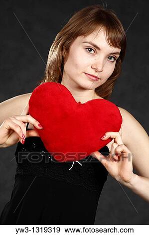 St Valentine's day - studio headshot of the pretty girl with red heart weared black tank top on gray background View Large Photo Image Stock Photo - St Valentine's day - studio headshot of the pretty girl with red heart weared black tank top on gray background. Fotosearch