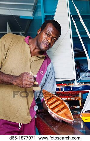 Stock Image - St Vincent and the Grenadines, Bequia, Port Elizabeth, Sargeant Brothers Model Boat Shop, model maker, R, MR-SVG-12-002. Fotosearch