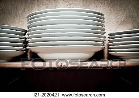 Stack of dishes in a cupboard. View Large Photo Image Stock Image - Stack of dishes in a cupboard.. Fotosearch