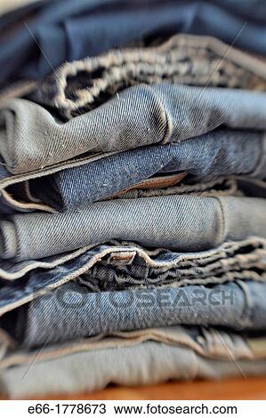 Stock Image - stack of folded pairs of blue jeans Shot with LensBaby for selective focus. Fotosearch