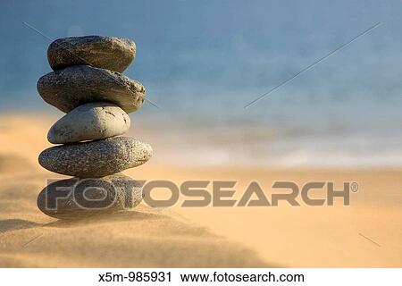 Stack of volcanic pebbles on a beach with blowing sand View Large Photo Image Stock Image - Stack of volcanic pebbles on a beach with blowing sand. Fotosearch