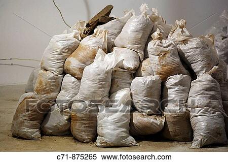 Stack of white construction bags filled with soil View Large Photo Image Stock Photography - Stack of white construction bags filled with soil. Fotosearch