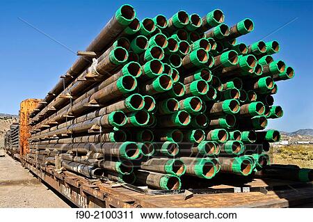Stacked drill pipe on rail cars in Colorado. View Large Photo Image Stock Image - Stacked drill pipe on rail cars in Colorado.. Fotosearch