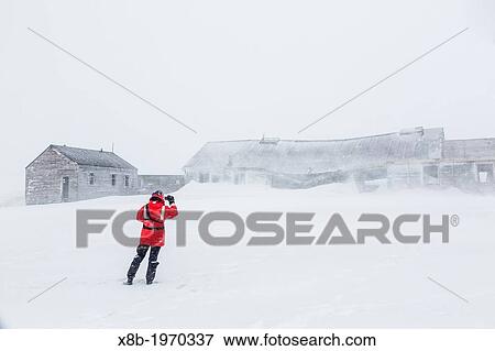Stock Photo - Staff from the Lindblad Expedition ship National Geographic Explorer (shown here is Photo Instructor CT Ticknor) working in Antarctica.. Fotosearch