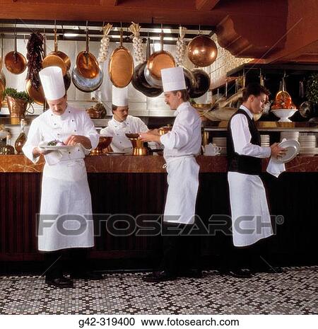Staff preps restaurant kitchen View Large Photo Image Stock Image - Staff preps restaurant kitchen. Fotosearch