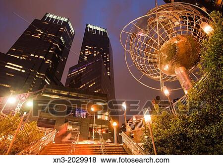 Stock Photo - Stairs to the underground, Globe Sculpture in front of Trump International Hotel and Tower, at left Time Warner Center, Columbus Circle, Midtown, Manhattan, New York City, USA.. Fotosearch