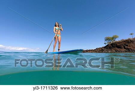 Stock Photograph - Stand up paddling at Black Rock, Maui, Hawaii. Fotosearch