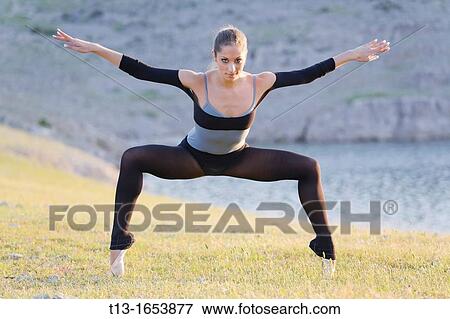 Standing on her tiptoes, attractive ballerina View Large Photo Image Stock Photo - Standing on her tiptoes, attractive ballerina. Fotosearch