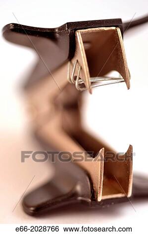 Staple remover on white background. Shot with selective focus. View Large Photo Image Stock Photograph - Staple remover on white background. Shot with selective focus.. Fotosearch