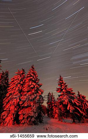 Stock Photo - Star tracks in winter sky, Hohen Meissner National Park, North Hessen, Germany. Fotosearch