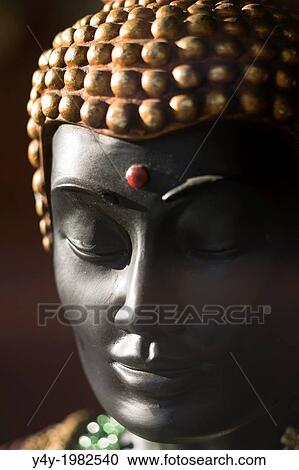Stock Image - Statue of meditating Buddha.. Fotosearch