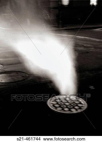 Steam pouring from a Manhole cover on New York's Lower Eastside is caputed at night in a 2second time exposure. The resulting photo is ghostly and ominous, and suggests the seedier side of Urban living. USA. View Large Photo Image Picture - Steam pouring from a Manhole cover on New York's Lower Eastside is caputed at night in a 2second time exposure. The resulting photo is ghostly and ominous, and suggests the seedier side of Urban living. USA.. Fotosearch