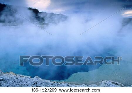 Steam rising off Sapphire Pool on a stormy evening, Biscuit Basin, Yellowstone National Park, WYOMING View Large Photo Image Stock Photo - Steam rising off Sapphire Pool on a stormy evening, Biscuit Basin, Yellowstone National Park, WYOMING. Fotosearch