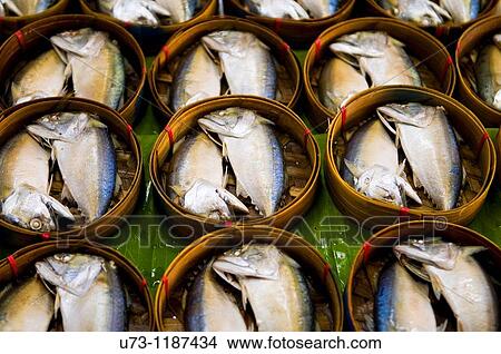 Picture - Steamed fish for breakfast sold in a colorful market in downtown Bangkok.. Fotosearch