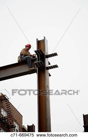 Steel construction worker anchoring steel View Large Photo Image Stock Photography - Steel construction worker anchoring steel. Fotosearch
