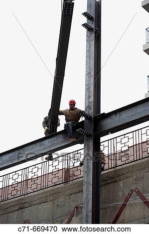 Steel construction workers raising steel View Large Photo Image Stock Image - Steel construction workers raising steel. Fotosearch