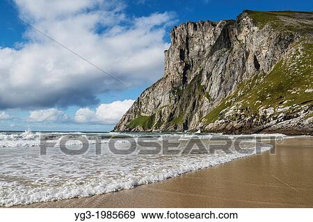 Steep cliffs of Ryten rise above Kvalvika beach, Lofoten Islands, Norway. View Large Photo Image Stock Photo - Steep cliffs of Ryten rise above Kvalvika beach, Lofoten Islands, Norway.. Fotosearch
