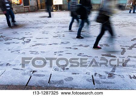 Stock Photography - Step marks on freshly snow-covered street. Rijeka, Croatia.. Fotosearch