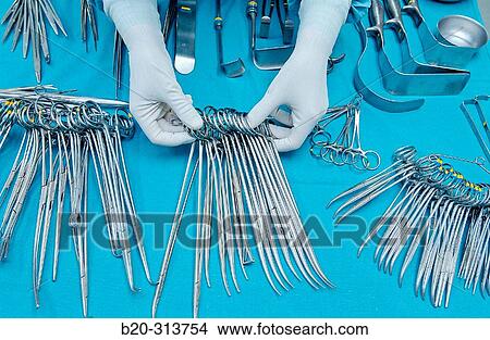 Picture - Sterilization works at surgery division of hospital. Fotosearch