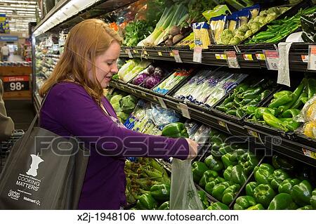 Sterling Heights, Michigan - Woman shops in the grocery section of a Walmart store. She was participating in a Cooking Matters" workshop that offered tips on buying healthy food on a budget. " View Large Photo Image Stock Photograph - Sterling Heights, Michigan - Woman shops in the grocery section of a Walmart store. She was participating in a Cooking Matters" workshop that offered tips on buying healthy food on a budget. ". Fotosearch