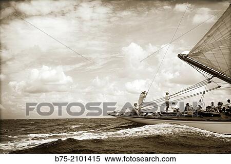 Stern of a classic sailboat in a regatta with sailors in the background at the Port Mahon, Menorca, Balearic Islands, Spain. View Large Photo Image Stock Photography - Stern of a classic sailboat in a regatta with sailors in the background at the Port Mahon, Menorca, Balearic Islands, Spain.. Fotosearch