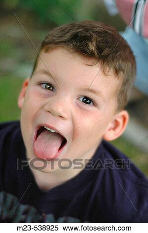 Sticking out his tongue, a little boy makes a funny face View Large Photo Image Stock Photography - Sticking out his tongue, a little boy makes a funny face. Fotosearch