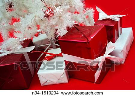 Still white Christmas tree with presents on red carpet. View Large Photo Image Picture - Still white Christmas tree with presents on red carpet.. Fotosearch