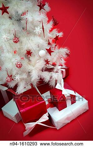 Still white Christmas tree with presents on red carpet. View Large Photo Image Stock Image - Still white Christmas tree with presents on red carpet.. Fotosearch