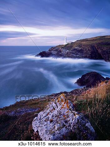 Stinking Cove and the lighthouse at Trevose Head at dusk viewed from Dinas Head on the North Cornwall coast near Padstow, Cornwall, England, United Kingdom View Large Photo Image Stock Photography - Stinking Cove and the lighthouse at Trevose Head at dusk viewed from Dinas Head on the North Cornwall coast near Padstow, Cornwall, England, United Kingdom. Fotosearch