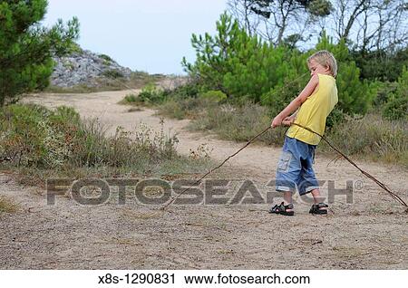 Stock photo of a 10 year old boy trying to pull out a tree root View Large Photo Image Stock Image - Stock photo of a 10 year old boy trying to pull out a tree root. Fotosearch