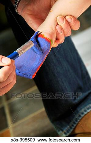 Stock Photo - Stock photo of a 3 year old girl enjoying some creative play with feet paints. Fotosearch
