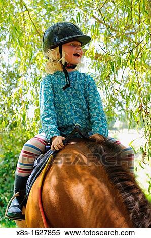 Stock photo of a 6 year old girl riding a pony View Large Photo Image Stock Photography - Stock photo of a 6 year old girl riding a pony. Fotosearch