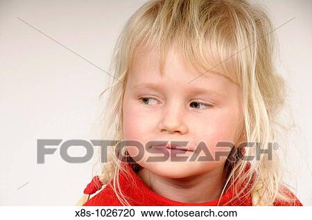 Stock Image - Stock photo of a blond haired four year old child looking to her right. Fotosearch