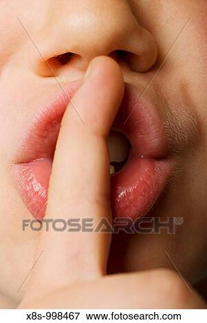 Stock Photo - Stock photo of a child with his finger over his mouth to say Shhhhhh. Fotosearch