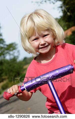 Stock photo of a five year old girl riding her scooter View Large Photo Image Stock Photograph - Stock photo of a five year old girl riding her scooter. Fotosearch