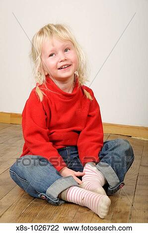 Stock photo of a four year old girl sitting crossed leg on a wooden floor View Large Photo Image Stock Image - Stock photo of a four year old girl sitting crossed leg on a wooden floor. Fotosearch