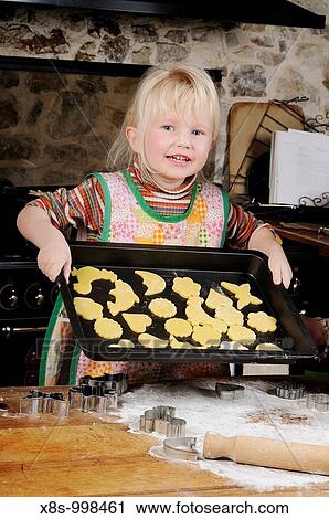 Stock photo of a four year old girl showing a tray of cookies in the kitchen View Large Photo Image Stock Image - Stock photo of a four year old girl showing a tray of cookies in the kitchen. Fotosearch