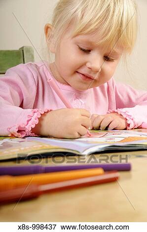 Stock photo of a four year old girl drawing pictures on a piece of paper View Large Photo Image Stock Photo - Stock photo of a four year old girl drawing pictures on a piece of paper. Fotosearch