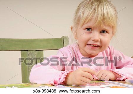 Stock photo of a four year old girl drawing pictures on a piece of paper View Large Photo Image Stock Photo - Stock photo of a four year old girl drawing pictures on a piece of paper. Fotosearch