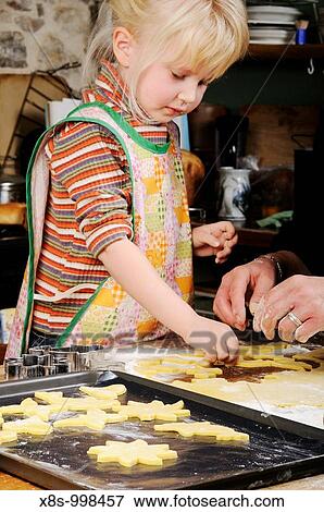 Stock photo of a four year old girl making cookies in the kitchen View Large Photo Image Stock Photo - Stock photo of a four year old girl making cookies in the kitchen. Fotosearch